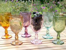 Lade das Bild in den Galerie-Viewer, 6 Bunte Weingläser von Chic Antique aus der Serie "Saint Emilion" mit Blattmotiv. Die Gläser stehen auf einem Holztisch, im Hintergrund ist eine Blumenwiese.