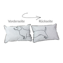Lade das Bild in den Galerie-Viewer, Outdoorkissen von Werner Voß mit Dackelmotiv. Der vordere Körperteil des Dackels ist auf der Vorderseite abgebildet, der hintere Teil auf der Rückseite. Das Kissen ist weiß mit schwarzem Motiv und schwarzer Paspel.