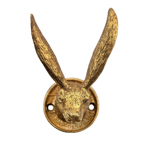 Wandhaken in Form eines goldenen Hasenkopfs, dessen Ohren als Haken dienen. 