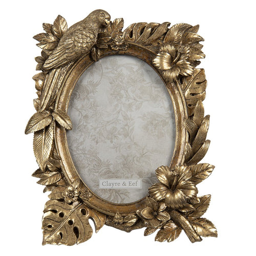Ovaler Bilderrahmen von Clayre und Eef mit großer goldener Verzierung im Urban Jungle Stil: Papagei, Pflanzenblätter wie Monstera und Palmen und Hibiskusblüten