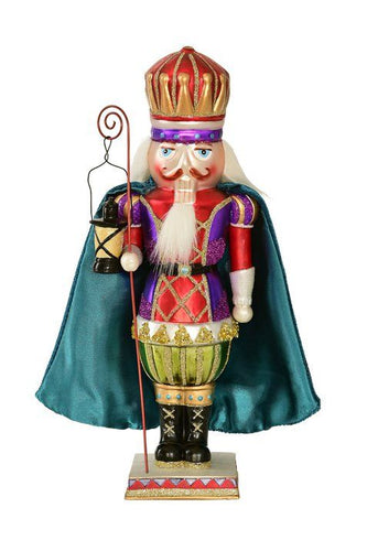 Deko-Figur von Gift Company in Form eines Nussknackers aus Glas in lila und rot mit blauem Umhang.