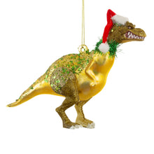 Lade das Bild in den Galerie-Viewer, Weihnachtsanhänger aus Glas in Form eines T-Rex- Dinosauriers mit Weihnachtsmütze und glitzernder Verzierung.
